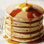 stacked Bisquick pancakes with syrup and butter