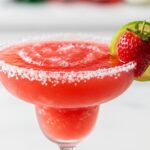 Frozen strawberry margarita in a salt-rimmed glass